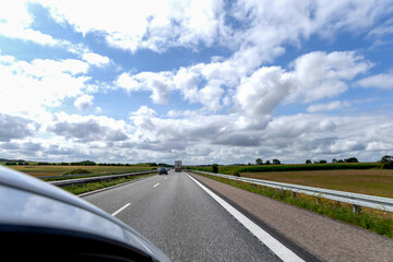 Fototapeta premium Highway with cars on a cloudy summer day.