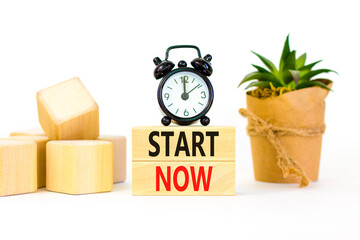 Start now symbol. Concept words Start now on beautiful wooden block. Beautiful white table white...