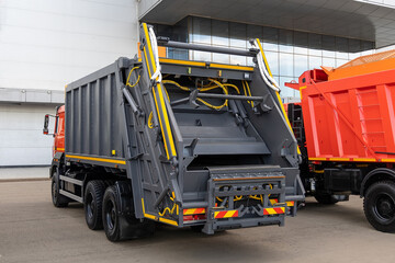 New garbage truck at a dealership or at an industry fair. Municipal transport for waste collection