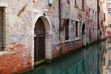 Salt damage to old bricks and marble in Venice, due to repeated flooding with salt water from the Adriatic coast of the Mediterranean Sea. Full image with erosion damage. Venice, Italy, Europe.