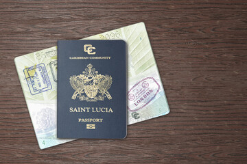 Two Saint Lucia passports, one of them open and showing international airport stamps