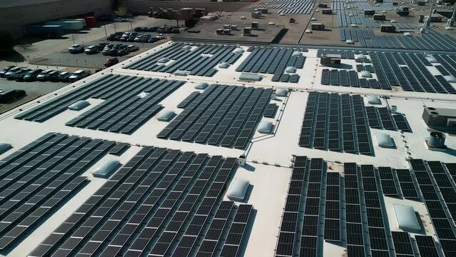 Drone flight fly over solar panels renewable green alternative energy on the roof. Above drone view