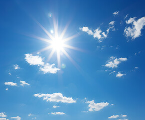 Naklejka na ściany i meble Shining sun at clear blue sky with copy space