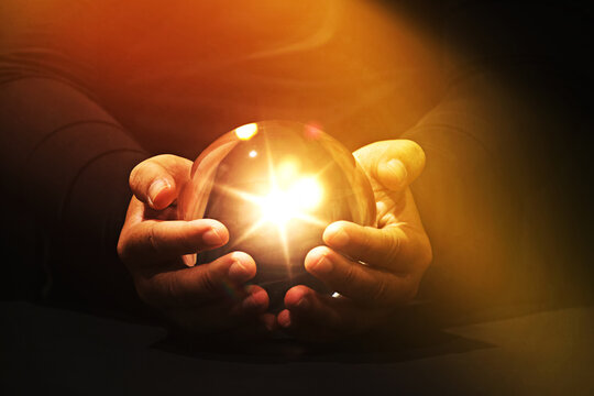 Spiritual background: hand holding powerful magic sphere,Fortune teller, mind power concept.	