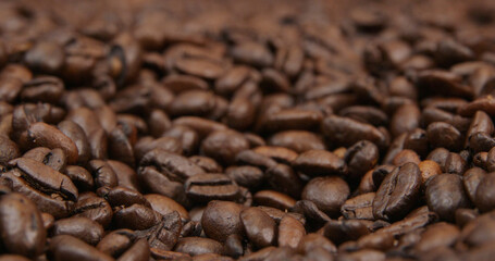 Coffee beans spread out on table close up