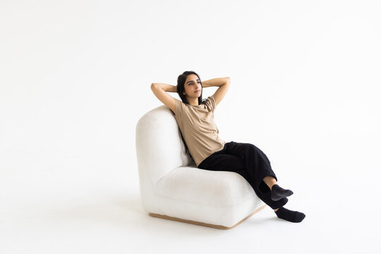 Portrait Of Indian Woman Smiling Sitting On The Chair On White Background