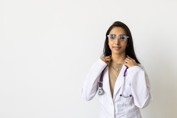 Indian youngwoman doctor portrait standing against white background.