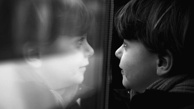 Introspective Close-Up of Child's Thoughtful Face Leaning on Train Window, Observing Scenery with Curiosity in monochromatic, black and white