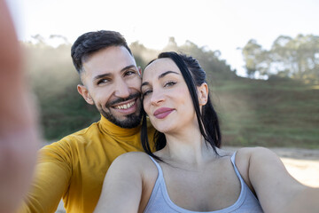 happy diverse couple celebrating their honeymoon trip to paradisiacal beach in summer