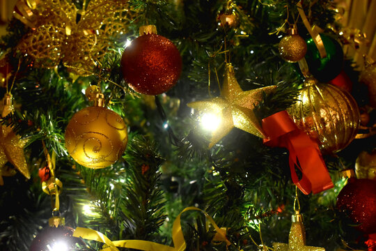 Beautiful Christmas ornaments on the Christmas tree with golden and red balls.  Christmas background.