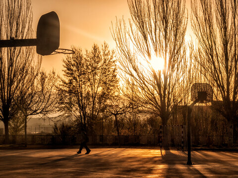 Vibrant Sunrise Street Park with Basketball Hoops – Abstract Stock Phot