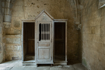 Detail of the wooden confessional of the ghost town church, it survived the attacks of the war