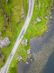 Aerial view of road and lake at Gap of Dunloe with rocks and vegetation