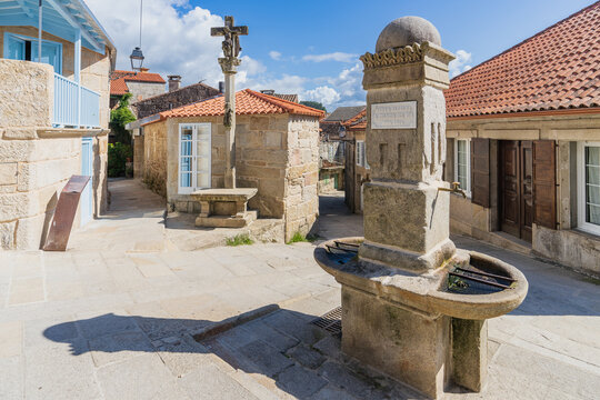 Plaza with fountain and cruise in the beautiful fishing village of Combarro, in Pontevedra, Galicia