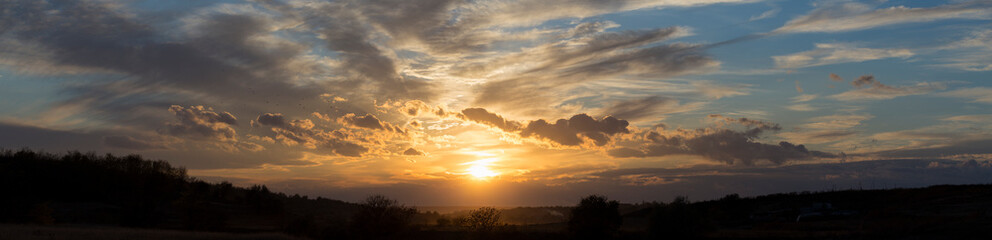 Rural landscape at sunset through the rain. Panorama.