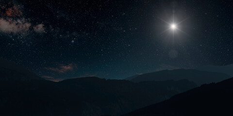 a Christmas star shines at night over the mountains of Bethlehem - obrazy, fototapety, plakaty