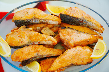 A bowl of grilled red fish. 
