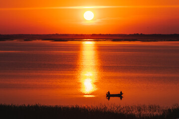 silhouette of a person in a boat on a sunset