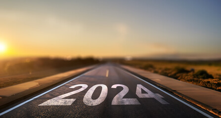 empty street with the new year 2024 written on the road - concept of setting goals for the next year - obrazy, fototapety, plakaty