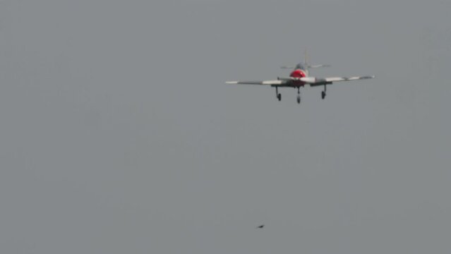 Retro plane flies at airshow. Two-seat sports trainer aircraft, designed for initial training and training of pilots. Soviet plane Yakovlev