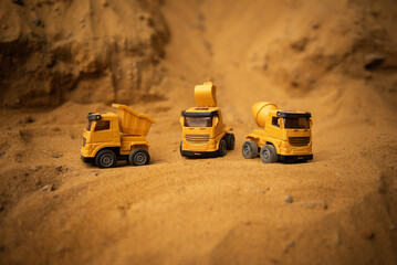 excavator, concrete mixer, truck for construction work. Toy cars. Photo for construction advertising