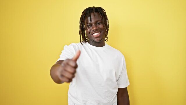 African american man smiling confident doing ok sign with thumb up over isolated yellow background