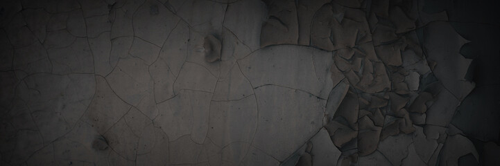 Dark wide panoramic background. Peeling paint on a concrete wall. Dark grunge texture of old cracked flaking paint. Weathered rough painted surface. Patterns of cracks. Darkness background for design. - obrazy, fototapety, plakaty