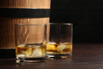 Tasty whiskey on wooden table, closeup. Space for text