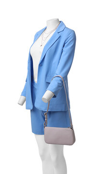 Female mannequin dressed in light blue suit and top with accessories isolated on white. Stylish outfit