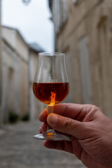 Tasting of cognac alcohol drink and view on old streets and houses in town Cognac, Grand Champagne,...