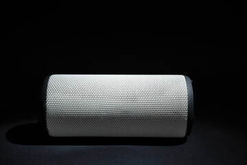 One portable bluetooth speaker on black background, space for text. Audio equipment