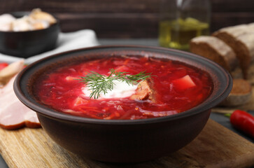 Tasty borscht with sour cream in bowl on grey table, closeup