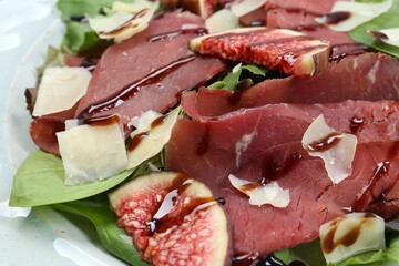 Delicious bresaola salad on plate, closeup view