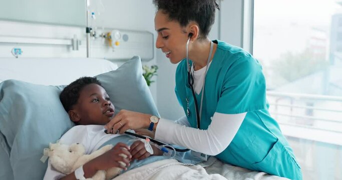 Happy woman, doctor and child checking heart beat, rate or monitoring health on bed at hospital. Female person, nurse or medical employee smile with stethoscope on little boy for healthcare at clinic