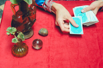 top view of unrecognizable female hands placing tarot deck on table, starting consultation