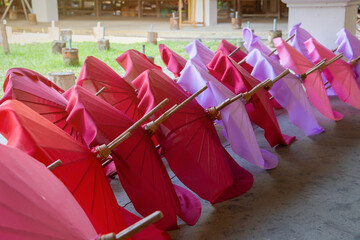 The plain colorful umbrellas are being dried for making souvenir in Chiang Mai province , Thailand.