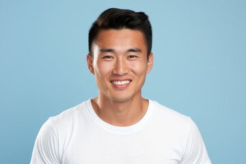 Fototapeta premium Portrait of a Happy Fictional Handsome Asian Male Model Smiling Candidly. Isolated on a Plain Colored Background. Generative AI. 