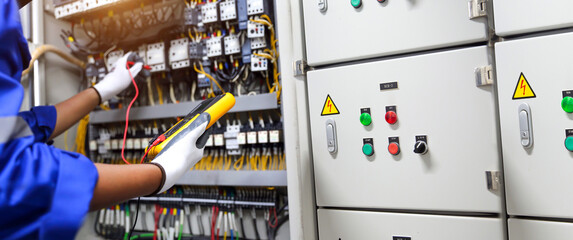 Electricity and electrical maintenance service. Engineer hand checking electric current voltage at...