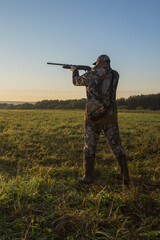 Hunter aiming with rifle.  Hunter man.