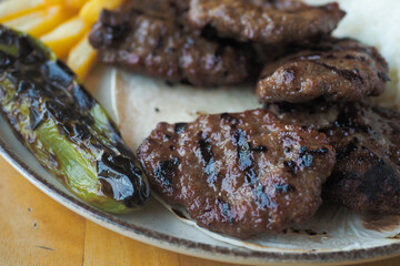 Kebab, traditional turkish meat food with salad on a plate .