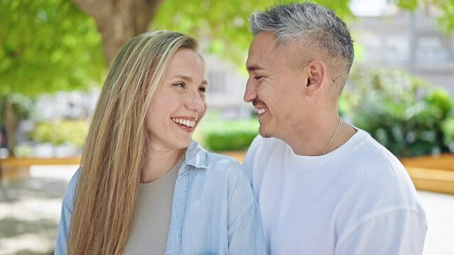 Man and woman couple smiling confident standing together at park