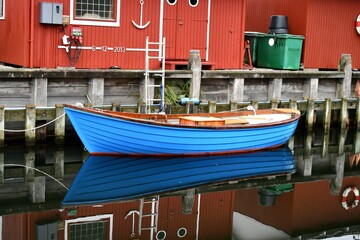 Fototapeta na wymiar Rowboat in harbor reflection