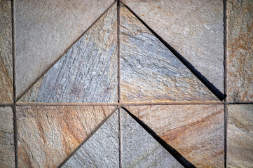 Triangular Stone Wall with an Upward Arrow Theme.