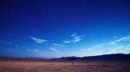 Fototapeta na wymiar Scenic view of a sandy desert under a starry sky at night. The tranquil desert landscape is illuminated by the shimmering stars above, creating a mesmerizing and peaceful scene