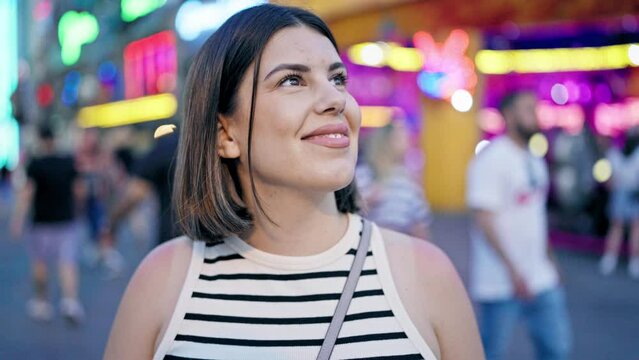 Young beautiful hispanic woman smiling looking around at Prater Vienna