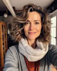 Happy middle aged woman taking a selfie at home - obrazy, fototapety, plakaty