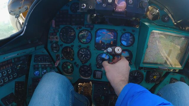 Cockpit of the Russian Mi-24 helicopter. Military transport helicopter. First-person view of instruments, sensors and controls. A hand is manipulating a control lever