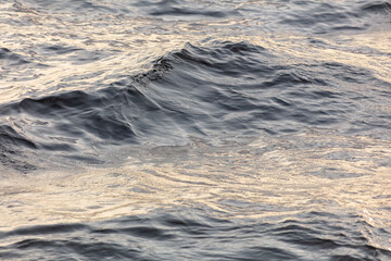 The surface of the water in the river at sunset