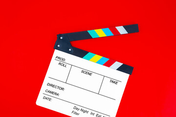 Blank film slate isolated on red background.
