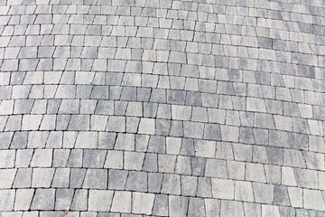 Stone pavement on the sidewalk as an abstract background. Texture